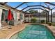 Inviting pool area with screened enclosure, brick pavers, and patio furniture at 7160 Spikerush Ct, Lakewood Ranch, FL 34202