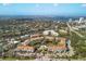 Aerial view of a community near the water, with a city skyline in the background at 850 S Tamiami Trl # 833, Sarasota, FL 34236