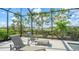 Relax by the pool on comfortable loungers in this private screened enclosure at 4653 Antrim Dr, Sarasota, FL 34240