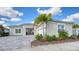 House exterior showcasing a modern design, two-car garage, and landscaped yard at 4653 Antrim Dr, Sarasota, FL 34240