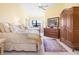 Guest bedroom with two beds and an armoire at 5283 Heron Way # 204, Sarasota, FL 34231