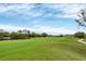 Peaceful golf course view with a pond in the background at 9630 Club South Cir # 6202, Sarasota, FL 34238