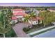 Aerial view of a stunning home with a tile roof, lush landscaping, and a circular driveway at 14619 Leopard Creek Pl, Lakewood Ranch, FL 34202