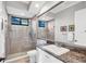 Bathroom features a vanity with granite countertop, large mirror and glass-enclosed shower at 14619 Leopard Creek Pl, Lakewood Ranch, FL 34202