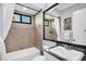 Bathroom features a shower-tub combo, framed mirror and a granite-topped vanity at 14619 Leopard Creek Pl, Lakewood Ranch, FL 34202