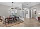 Elegant dining room with decorative chandelier, large windows, and a beautiful decorative rug at 14619 Leopard Creek Pl, Lakewood Ranch, FL 34202