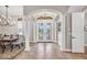 Grand foyer with arched entryway, tile flooring, and elegant glass double doors leading to the outside at 14619 Leopard Creek Pl, Lakewood Ranch, FL 34202