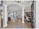 Spacious foyer featuring tile flooring, decorative columns, and an open view of the living and dining areas at 14619 Leopard Creek Pl, Lakewood Ranch, FL 34202