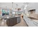 Well-appointed kitchen with stainless steel appliances, white cabinetry, and seamless flow to the Gathering room at 14619 Leopard Creek Pl, Lakewood Ranch, FL 34202