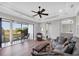 Inviting living room opens to a screened lanai with views of the golf course at 14619 Leopard Creek Pl, Lakewood Ranch, FL 34202