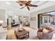 Bright, open living area with large ceiling fan and sliding doors to the outdoor pool area at 14619 Leopard Creek Pl, Lakewood Ranch, FL 34202