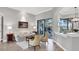 Bright living room with tile flooring, neutral decor, and access to the screened lanai and pool area at 14619 Leopard Creek Pl, Lakewood Ranch, FL 34202