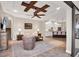 Spacious living room featuring a ceiling fan, a cozy seating area, and an open layout to the kitchen at 14619 Leopard Creek Pl, Lakewood Ranch, FL 34202