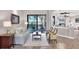 Comfortable living room with neutral tones, tile flooring, and sliding glass doors to a covered lanai at 14619 Leopard Creek Pl, Lakewood Ranch, FL 34202