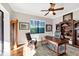 Cozy home office with hardwood floors, ceiling fan, and a built-in bookcase perfect for work or study at 14619 Leopard Creek Pl, Lakewood Ranch, FL 34202