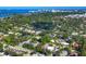 An aerial daytime view shows the property nestled among lush trees, close to the bay and city at 1884 Grove St, Sarasota, FL 34239