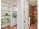 Bright, well-organized bathroom with plentiful cabinetry, open glass shelving, and a view of the stylish shower at 1884 Grove St, Sarasota, FL 34239
