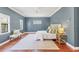 Spacious main bedroom suite featuring hardwood floors, plush bedding, abundant natural light, and a ceiling fan at 1884 Grove St, Sarasota, FL 34239