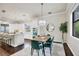 Open dining area features modern lighting, green velvet chairs, and seamless access to the kitchen at 1884 Grove St, Sarasota, FL 34239