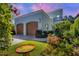 Charming two-story home with a two-car garage, mature landscaping, and a decorative bird bath at 1884 Grove St, Sarasota, FL 34239
