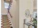 Inviting foyer with staircase, table, decor, and mirror, offering a glimpse into the home's interior at 1884 Grove St, Sarasota, FL 34239