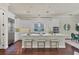 Bright kitchen features a central island with bar stool seating, stainless appliances, and sleek countertops at 1884 Grove St, Sarasota, FL 34239
