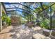 Spacious screened lanai with a brick accent wall, comfortable seating, and natural light at 1884 Grove St, Sarasota, FL 34239