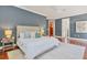 Stylishly appointed main bedroom with beautiful furnishings, hardwood flooring, and access to the en-suite bathroom at 1884 Grove St, Sarasota, FL 34239