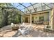 Beautiful patio with an outdoor fire pit, lounge area, and stone water feature at 1884 Grove St, Sarasota, FL 34239