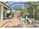 Enclosed patio with a stone water feature, outdoor seating, and a cozy firepit area at 1884 Grove St, Sarasota, FL 34239