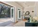 Cozy sitting room with sliding glass doors to screened lanai and wine bar at 1884 Grove St, Sarasota, FL 34239