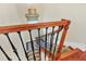 Well-lit staircase with carpeted treads and a decorative wooden handrail leading to the lower level at 1884 Grove St, Sarasota, FL 34239