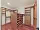 Expansive walk-in closet with custom shelving and drawers, providing ample storage and organization solutions at 1884 Grove St, Sarasota, FL 34239