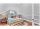 A well lit bedroom with a comfortable bed and bench at 3101 Riverview Blvd, Bradenton, FL 34205