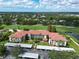 Expansive aerial view of a beautiful condo complex with well-manicured landscaping and a nearby golf course at 6503 Stone River Rd # 302, Bradenton, FL 34203