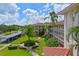 Exterior view of condo with well-maintained landscaping, sidewalks, and covered parking, evoking a peaceful and inviting atmosphere at 6503 Stone River Rd # 302, Bradenton, FL 34203