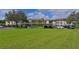 Condo complex featuring ample parking and green space at 6503 Stone River Rd # 302, Bradenton, FL 34203