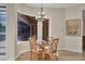 Breakfast nook with a glass-top table, wood chairs, and plenty of natural light at 9915 Old Hyde Park Pl, Bradenton, FL 34202