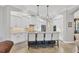 Modern kitchen with white cabinets, an island, and stainless steel appliances at 14619 Leopard Creek Pl, Lakewood Ranch, FL 34202
