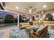 Outdoor kitchen and seating area with pool view at 14619 Leopard Creek Pl, Lakewood Ranch, FL 34202