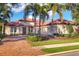 Beautiful one-story home with tile roof, palm trees, and a brick driveway at 14619 Leopard Creek Pl, Lakewood Ranch, FL 34202