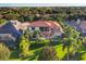 Luxury home with tile roof, pool, and lush landscaping at 14619 Leopard Creek Pl, Lakewood Ranch, FL 34202