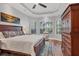 Main bedroom with large bed, ample closet space, and window seating at 14619 Leopard Creek Pl, Lakewood Ranch, FL 34202
