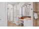 Elegant bathroom features a vanity with a marble countertop, large mirror, and a shower at 14619 Leopard Creek Pl, Lakewood Ranch, FL 34202