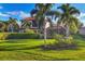 Landscaped backyard with lush lawn and two-story home at 14619 Leopard Creek Pl, Lakewood Ranch, FL 34202