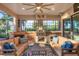 Spacious outdoor kitchen with seating area, grill, fireplace and pool view at 14619 Leopard Creek Pl, Lakewood Ranch, FL 34202