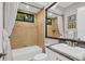 Clean bathroom with a shower/tub combo, granite countertop, and white cabinetry at 14619 Leopard Creek Pl, Lakewood Ranch, FL 34202