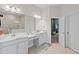 Double vanity bathroom with marble countertop and view of shower at 14607 Swiss Bridge Dr, Lithia, FL 33547