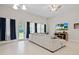 Bright living room features a large sectional sofa and access to backyard at 14607 Swiss Bridge Dr, Lithia, FL 33547