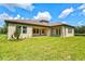Back exterior of house showing patio and lawn at 14607 Swiss Bridge Dr, Lithia, FL 33547